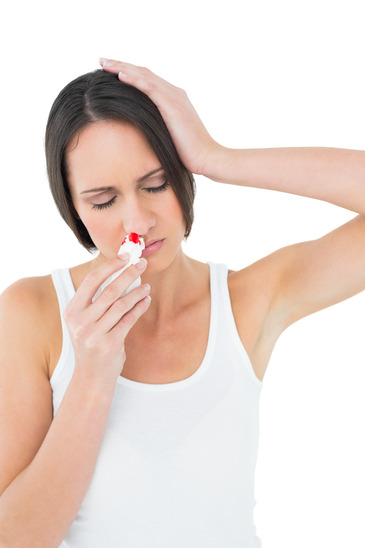 Woman in White Shirt having a Nose Bleed