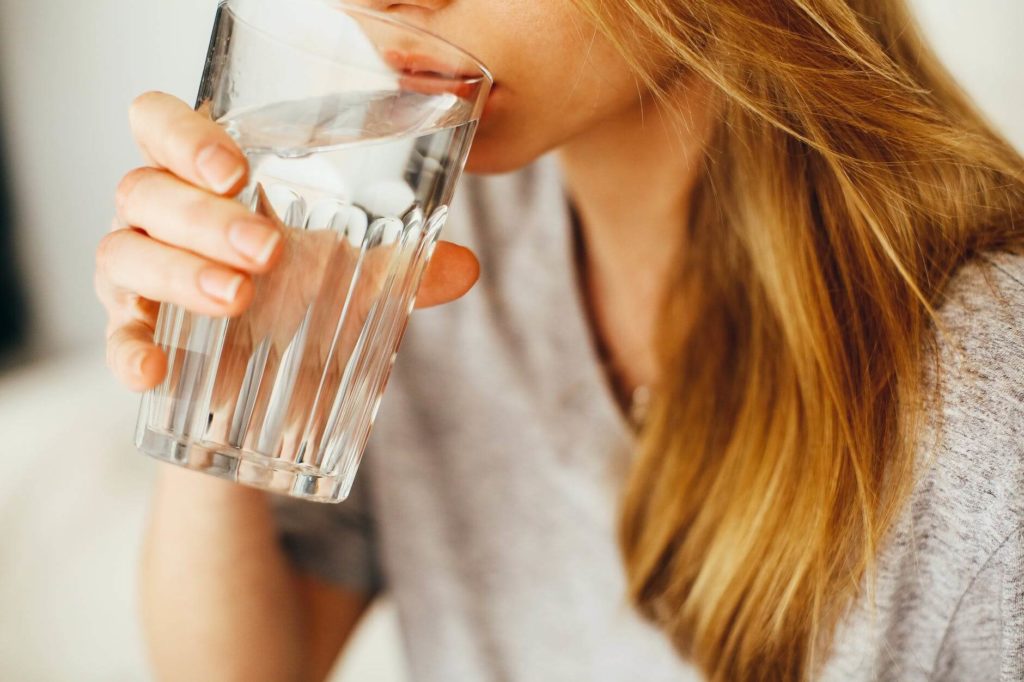 Young woman drinking a glass of Water